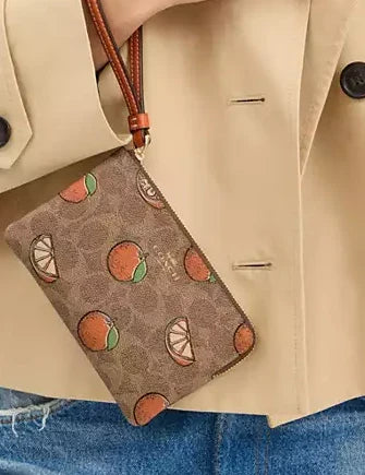 Coach Corner Zip Wristlet In Signature Canvas With Orange Print